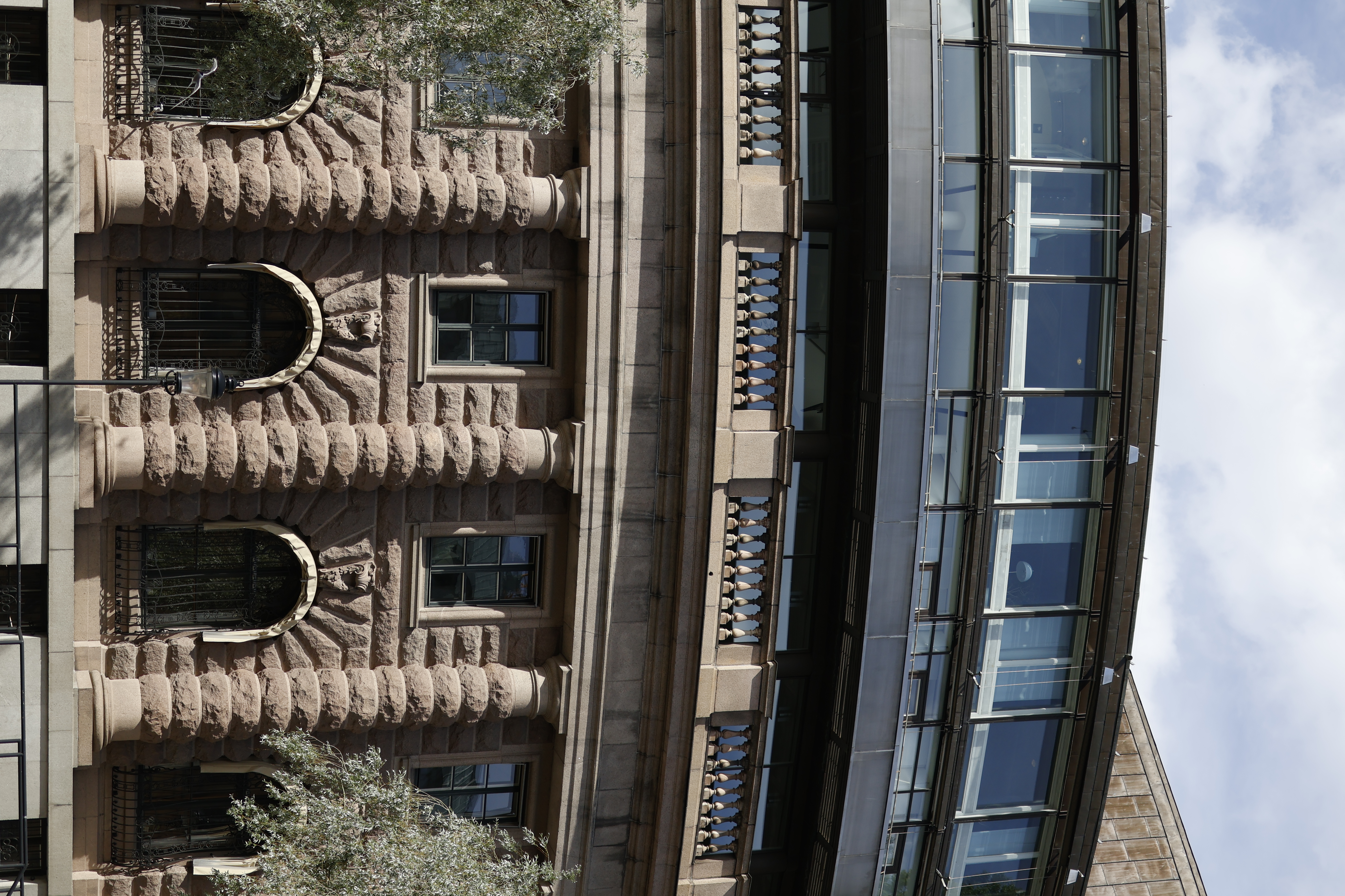 Old sandstone facade beside modern glass